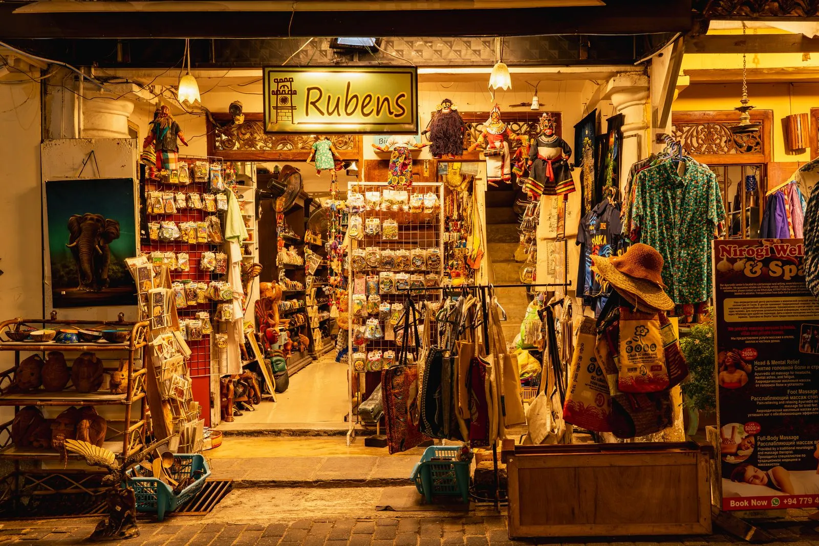 Cozy nighttime street view of "Rubens" shop in Galle, featuring local crafts and gifts.